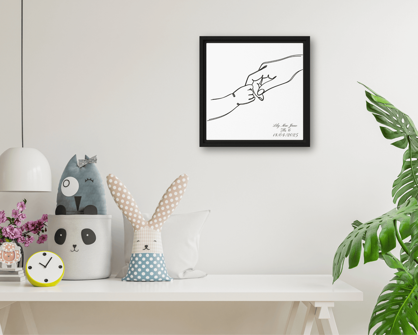 Black framed "{{product-type}}" with a personalised line art drawing of a mother's hand holding a baby's hand. The "{{title}}" design is a perfect new mum gift.