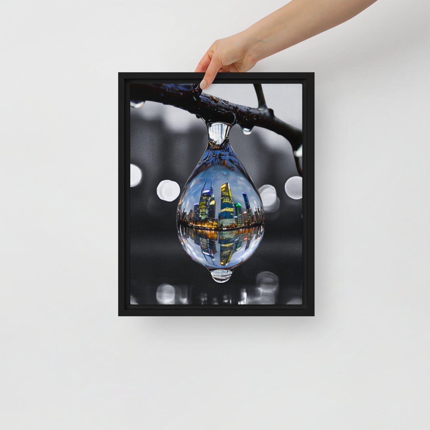 Framed canvas art print of a colorful city skyline reflected in a water droplet. Features unique abstract photography with vibrant colors against a monochrome background. Modern and stylish wall decor.
