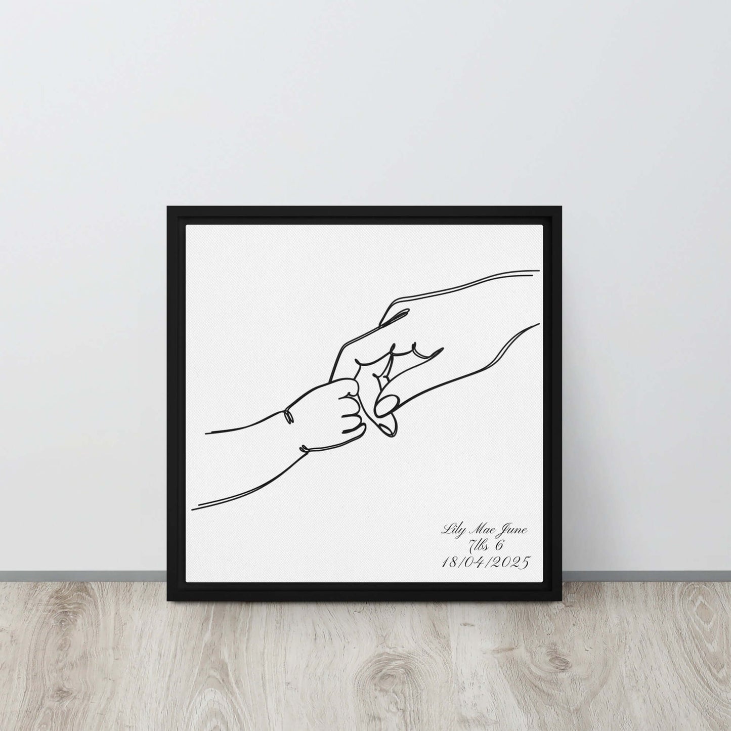 Black framed "{{product-type}}" with a personalised line art drawing of a mother's hand holding a baby's hand. The "{{title}}" design is a perfect new mum gift.