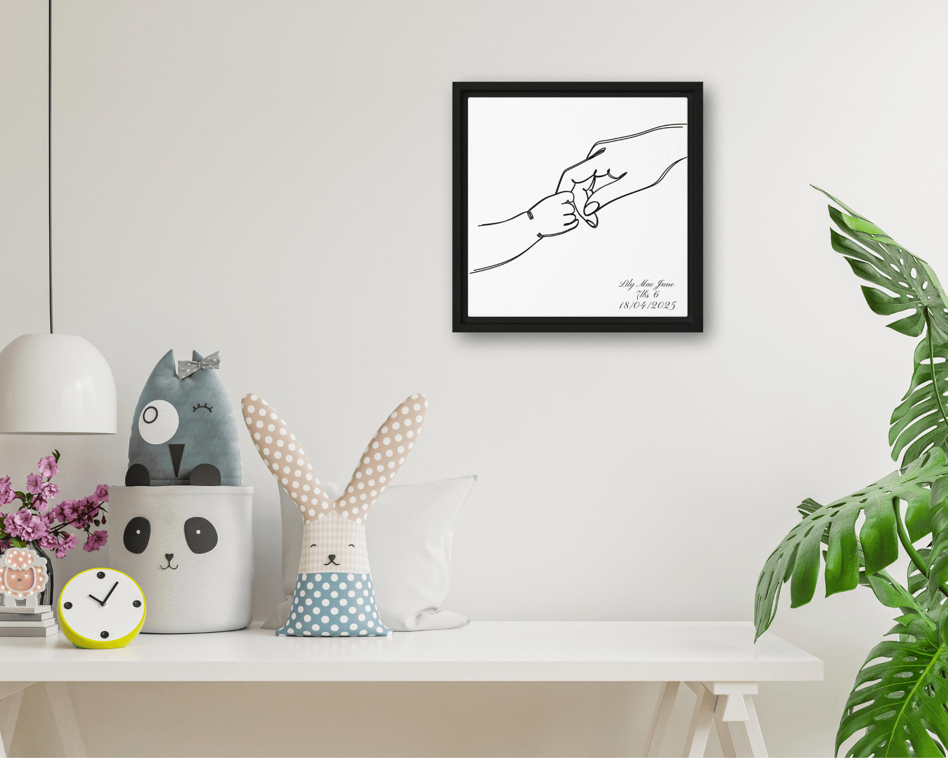 Black framed "{{product-type}}" with a personalised line art drawing of a mother's hand holding a baby's hand. The "{{title}}" design is a perfect new mum gift.