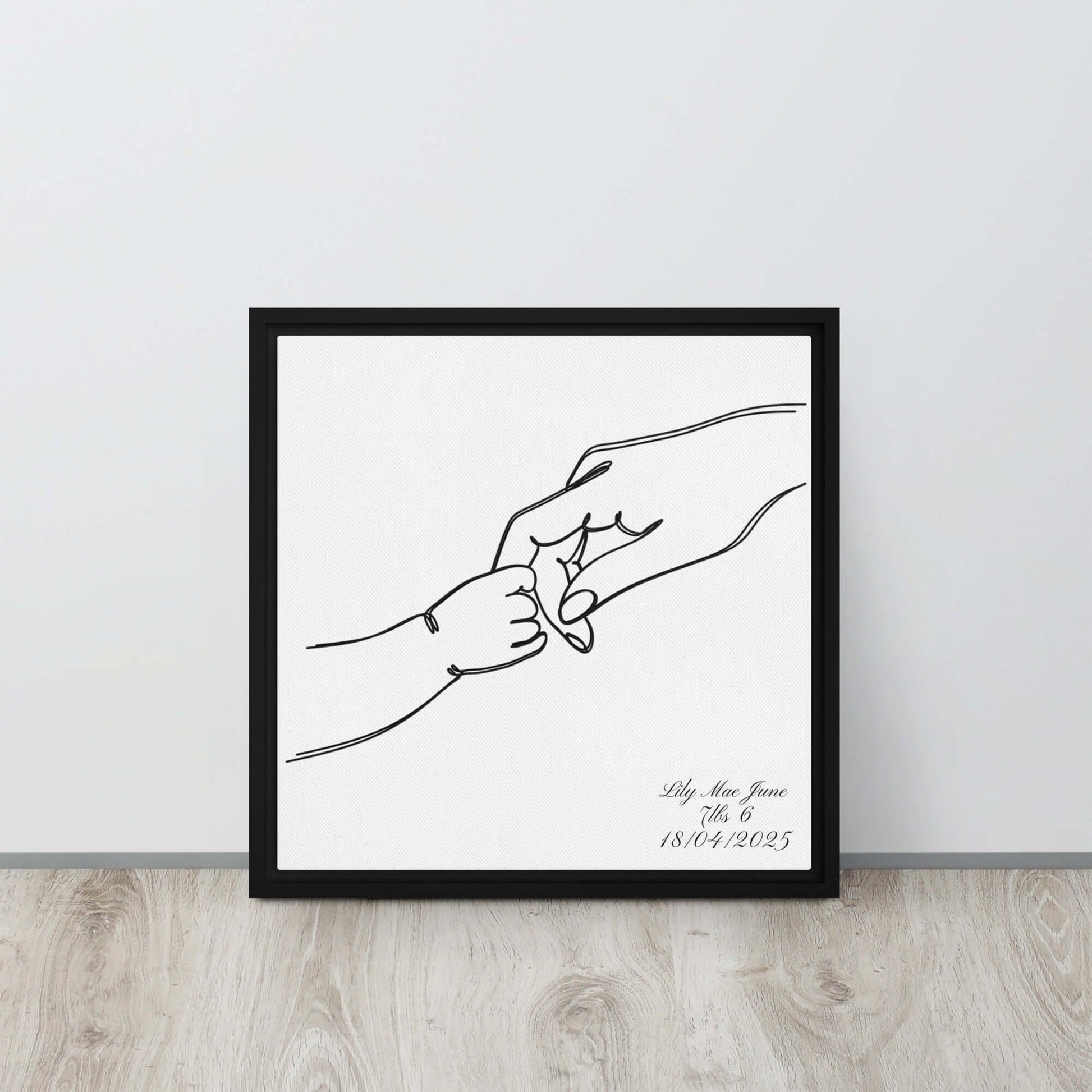 Black framed "{{product-type}}" with a personalised line art drawing of a mother's hand holding a baby's hand. The "{{title}}" design is a perfect new mum gift.